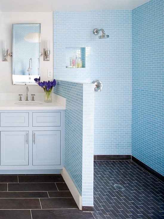 bright blue tiles paired with navy ones in the shower and a light blue vanity