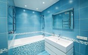 a contemporary bathroom fully clad with bright blue tiles looks bold and raises your mood