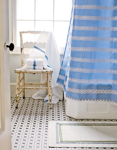 a striped blue curtain can add a colorful accent to the bathroom and make it brighter
