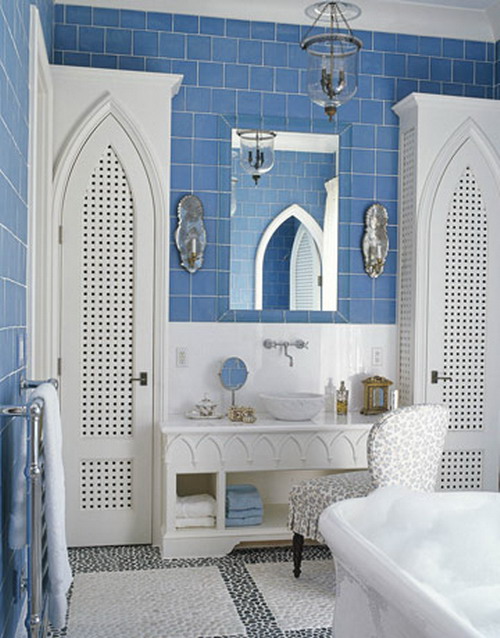 a vintage-inspired bathroom with blue subway tiles and white touches and furniture