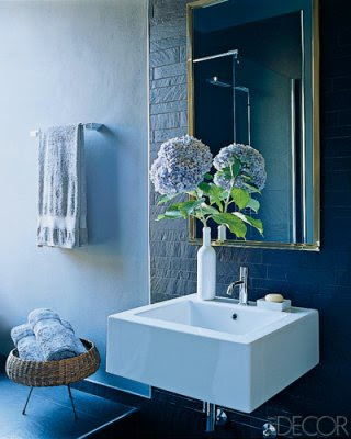 matte navy tiles and a navy tile floor for a chic and bold bathroom plus light blue towels
