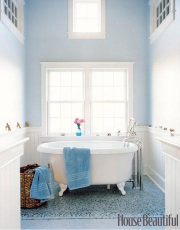 a light blue bathroom and a bright blue tile wall is refreshed with white touches and furniture
