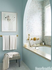 a serenity blue bathroom paired with marble tiles for a chic and refined combo
