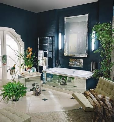 a luxurious midnight blue bathroom with neutrals and touches of mirror plus potted greenery