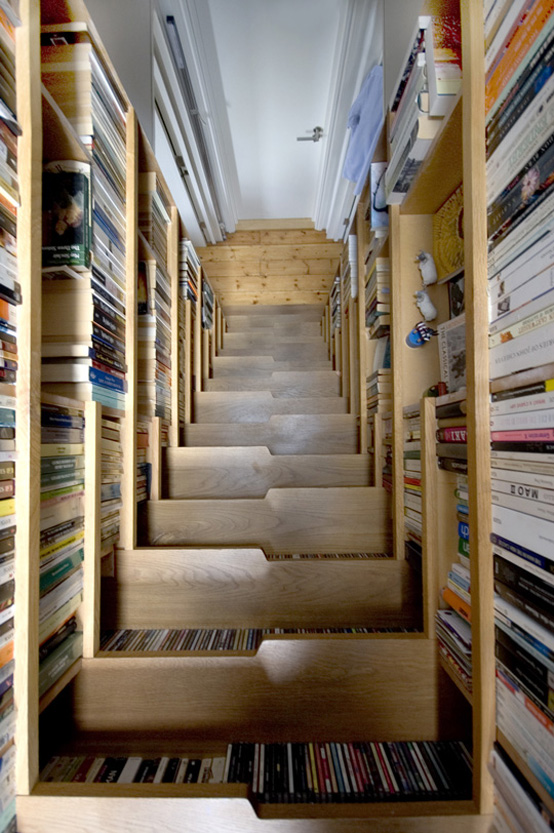 Levitate Architects used a staircase to a loft-like bedroom to create an enormous amount of book storage space. Even though the staircase isn't very compact but could accomodate so many books that it would save some space anyway.