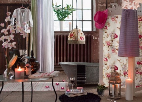 an eclectic bathroom with candles, a metal tub, a floral lamp and a matching screen