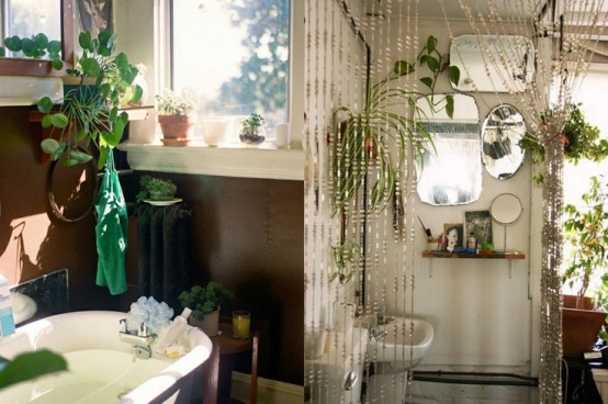 a contemporary bathroom with boho touches - greenery, beaded curtains and an arrangement of mirrors