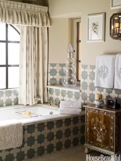 a neutral Moroccan inspired bathroom with Moroccan tiles, an inlay wooden vanity and printed curtains