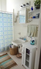 a white bathroom with various furniture, boho textiles for a touch of color