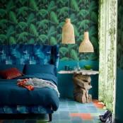 moody tropical print wallpaper, a nightstand made of driftwood and a stone countertop, wicker pendant lamps