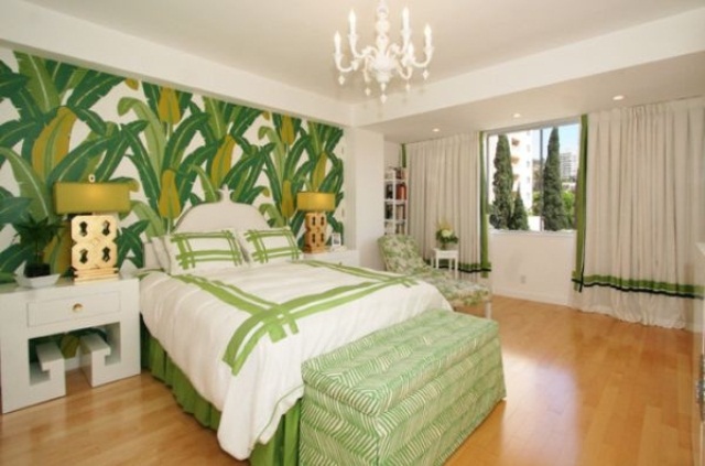 a tropical wallpaper statement wall, bright green touches, a chic chandelier for a glam tropical bedroom