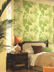 a tropical print statement wall, dark stained wooden furniture, potted palm trees and touches of rust