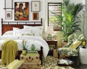 a gallery wall with tropical-inspired artworks, a potted palm, a tropical print chair and touches of green and pistachio