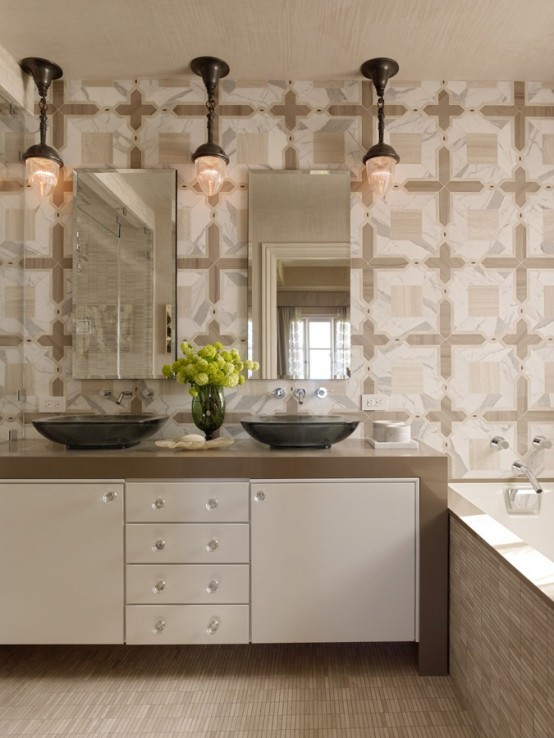 a neutral modern bathroom with a built-in vanity, mismatching tiles, two tinks and mirrors and vintage pendant lamps