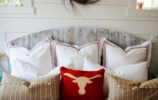 a bed with a whitewashed headboard that feels shabby chic like and adds vintage charm to the room