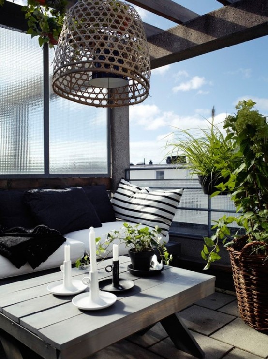 a Scandinavian terrace with a roof, a bench with pillows, a reclaimed wood table and a woven lamp over the table, some potted greenery a Scandinavian terrace with a roof, a bench with pillows, a reclaimed wood table and a woven lamp over the table, some potted greenery