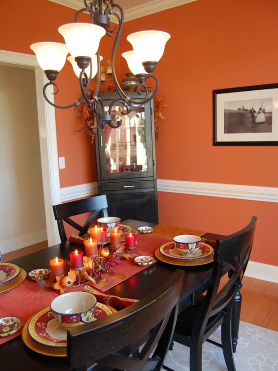 a vintage candelabra with faux leaves, pumpkins and bold pillar candles is a gorgeous and refined Thanksgiving centerpiece to rock