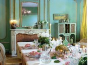 a beautiful and refined French dining room with turquoise walls, gilded touches, a fireplace, yellow curtains, a table and refined and chic chairs