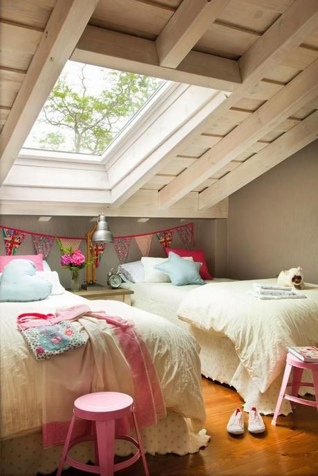 a relaxed attic shared girls' bedroom with beds, vintage bedding and a nightstand, pink stools and a bright fabric banner is very cool and fresh a relaxed attic shared girls' bedroom with beds, vintage bedding and a nightstand, pink stools and a bright fabric banner is very cool and fresh