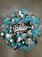 a pretty silver and tiffany blue Christmas wreath of ribbons, ornaments, twigs and snowflakes