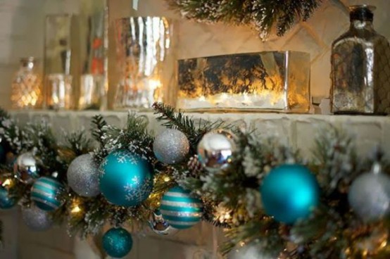 a garland with silver and tiffany blue ornaments and lights is a pretty decoration for indoors and outdoors