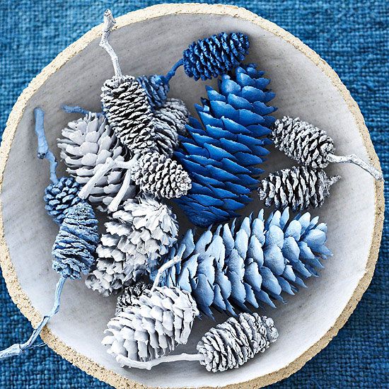 a bowl with white, silver and blue and electric blue pinecones is a lovely frozen Christmas centerpiece or decoration to rock