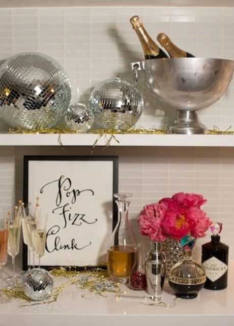 silver disco balls and bold pink blooms plus gold tinsel will make your NYE party fun, bold and cool