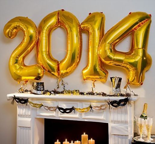 gold number balloons attached over the fireplace will be a nice and easy NYE decoration, you can make it last minute