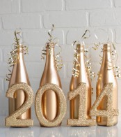 gold bottles, gold ribbon and gold glitter numbers to make your NYE party decor ultimate and bright