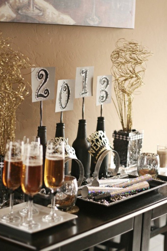 black bottles with numbers on top are amazing to show off what year is coming and making such decor is easy and fast