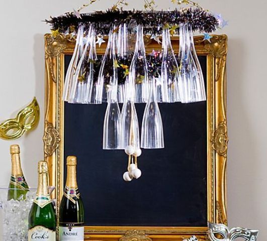 a tiered purple tinsel chandelier for holding glasses is a fun and cool idea for a NYE party