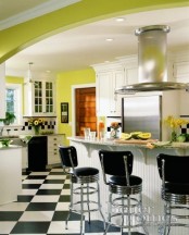 a retro kitchen with neon green walls, green printed textiles and potted plants, yellow blooms in vases