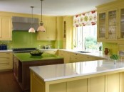 a vintage yellow kitchen with a green tile backsplash and a green tabletop on the kitchen island plus a floral curtain
