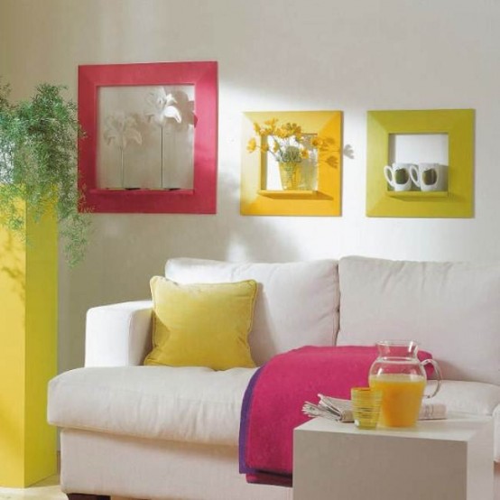 bold textiles, a sunny yellow plant stand and colorful frames enliven the living room making it feel summer-like