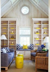 sunny yellow accessories and pillows plus a side table make the space look super bold and bright