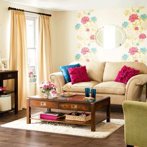 a bright floral wall, colorful furniture and pillows bring a strong summer feel to the space