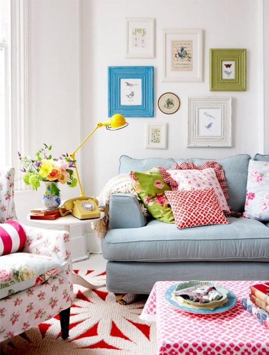 bright printed floral pillows and furniture, a bold gallery wall and rugs for a fun and bold summer living room