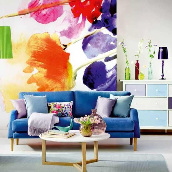 a super bright floral artwork and matching bright pillows for a bold summer feel in the living room