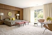 a mid-century modern bedroom with a fluffy carpet, a wood covered statement wall, leather chairs and pink stools
