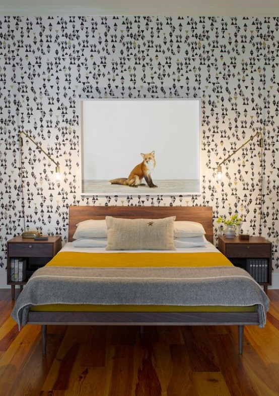 a catchy mid-century modern bedroom with geometric wallpaper, simple stained furniture and gilded table lamps