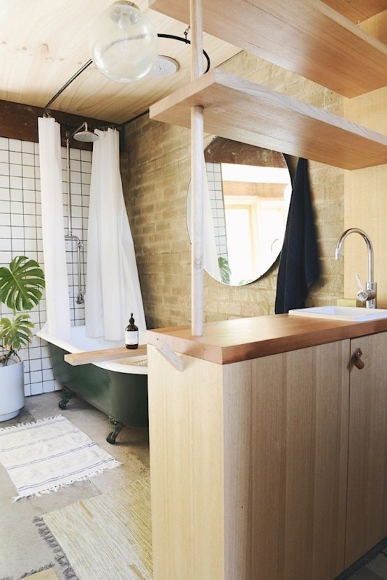 Chic Brick Bathroom With A Retro Green Bathtub