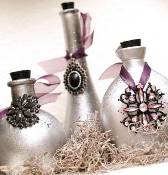 silver bottles accented with oversized jewelry pieces are a nice option for a Halloween party in glam style