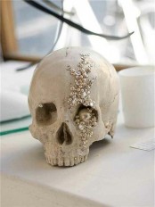 a bejeweled human skull with sequins, beads and pearls is a lovely Halloween decor idea to DIY