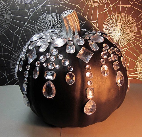 a fantastic black pumpkin decorated with oversized crystals is a great Halloween decoration to rock
