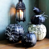 black and white Halloween pumpkins with beads and sequins, letters and a crow are a cool arrangement to rock
