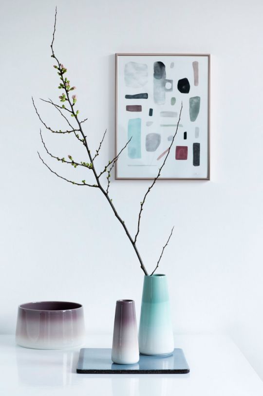 a fall Nordic centerpiece of a mirror and ombre vases in purple and turquoise plus branches for a Nordic feel