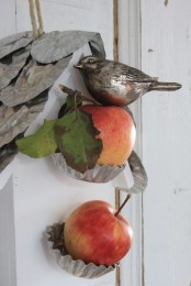 fall Nordic decor with apples on metal holders, a fake bird and a fake bird house