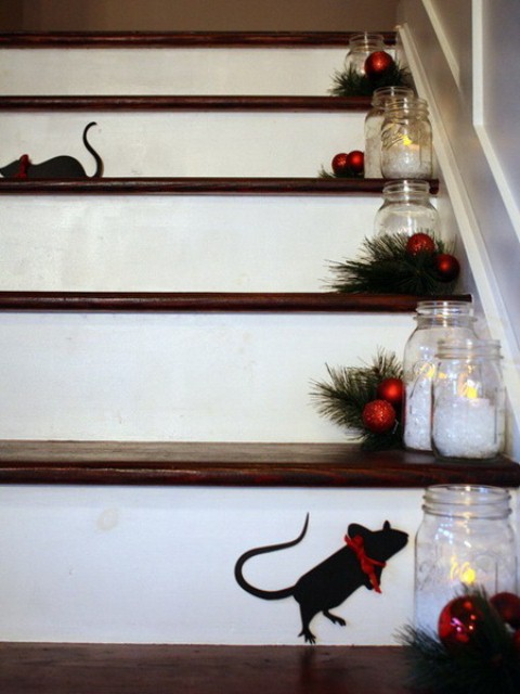 Mason jar lanterns combined with pine trimmings and red ornaments could spice up each step's decor.