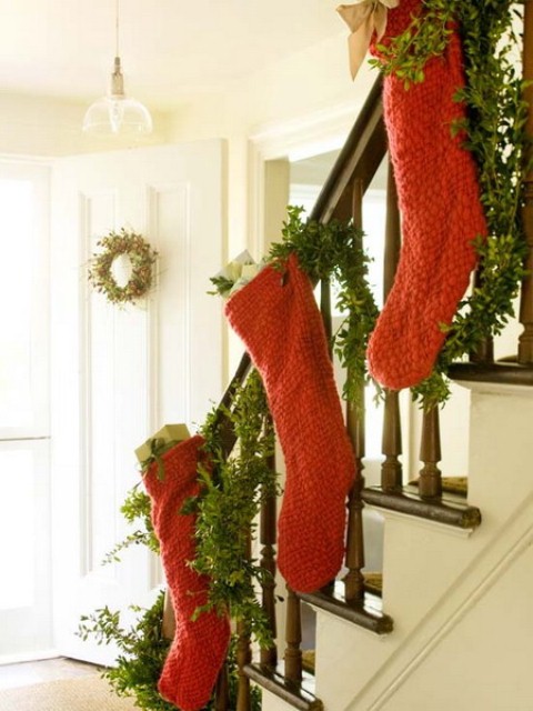 Christmas Stairs Decoration Ideas Add to the traditional staircase evergreen swag some Christmas stockings in seasonal colors.