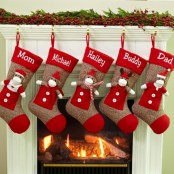 a Christmas mantel with evergreens and berries, fun monkey stockings to add a bit of fun to the space